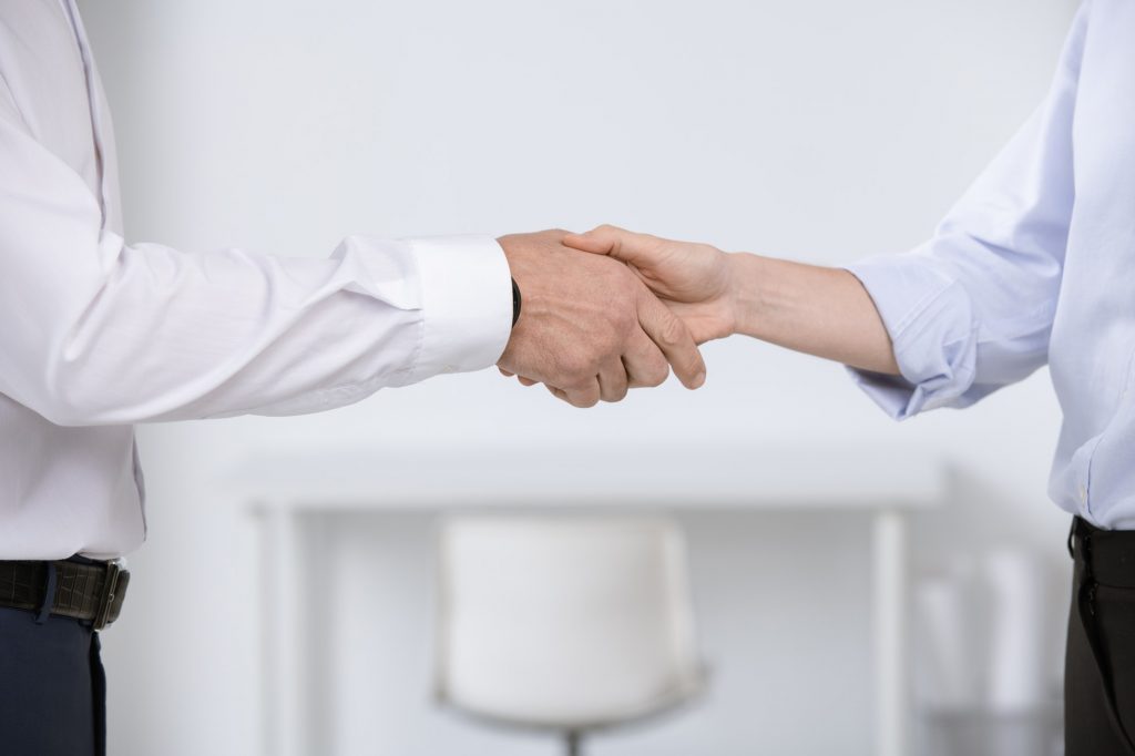 Hands of business partners greeting each other by meeting or after negotiation