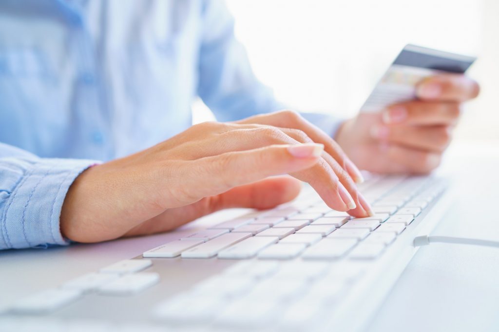 Woman using a credit card for online payments. The concept of on